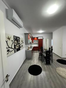 a living room and a kitchen with a table and chairs at Green Berat Villa in Uznovë +2 photos