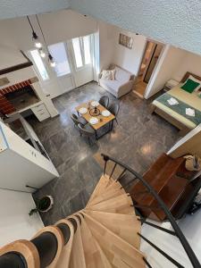 a living room with a staircase and a room with a bed at Apartments Peronja Jelsa Seafront in Jelsa