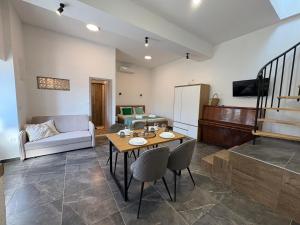 a living room with a table and a couch at Apartments Peronja Jelsa Seafront in Jelsa