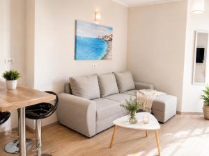 a living room with a couch and a table at Center Vibes Lux in Rijeka