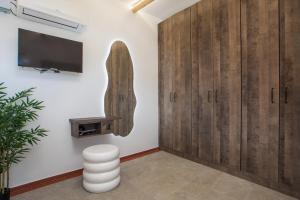 a room with wooden cabinets and a flat screen tv at Aegora Residence in Kalithies