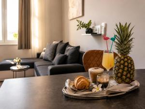 a table with a tray of croissants and drinks on it at Center Vibes Lux in Rijeka