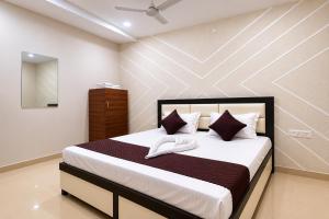 a bedroom with a large bed with white sheets and pillows at Hotel Triple A in Bhucho