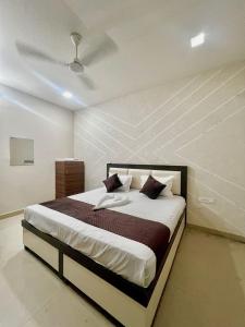 a bedroom with a large bed in a room at Hotel Triple A in Bhucho