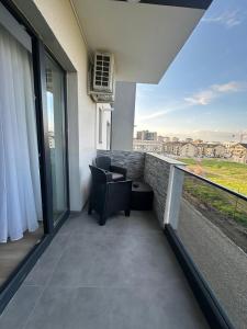 a balcony with two chairs and a view of the city at Luxury Vibes in Şelimbăr