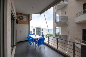a balcony with a table and chairs on it at Mirage Bay Deluxe in Sarandë