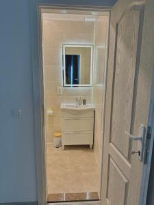 a bathroom with a sink and a mirror at Camino apartmani in Dračevo +38 photos