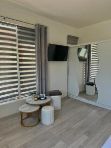 a living room with a table and a tv at Camino apartmani in Dračevo