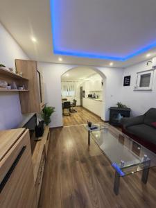 a living room with a glass table and a couch at Apartman Manuela in Šibenik
