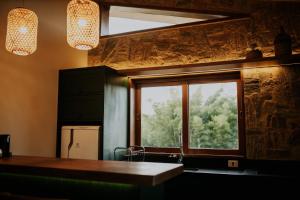 a kitchen with a window and a sink and a counter at Villa Arouca in Areal +131 photos