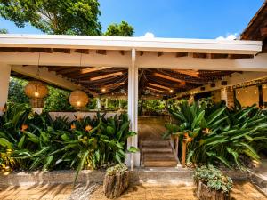 a porch of a house with trees and plants at Hotel Casa Madero in Envigado