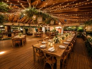 a long table in a restaurant with lights at Hotel Casa Madero in Envigado