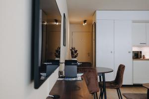 a kitchen and dining room with a table and a mirror at Apartment in Engelberg in Engelberg