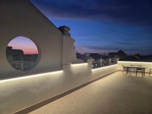a balcony with a table and chairs at night at Plaza España AT in Alcazar de San Juan