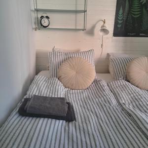 a bedroom with a bed with a clock on the wall at Gästhus öppen planlösning in Oskarshamn
