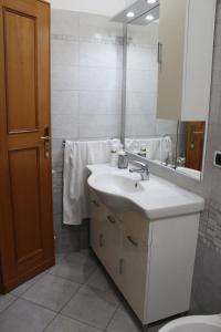 a bathroom with a sink and a toilet and a mirror at Villa Severino Ferrari in Anzio in Anzio +49 photos