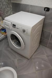 a white washing machine sitting next to a toilet at Villa Severino Ferrari in Anzio in Anzio