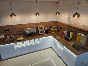 a kitchen with white cabinets and a counter at Pansion Karolina in Međugorje
