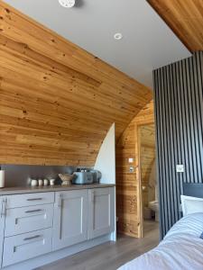 a bedroom with a bed and a wooden ceiling at Celtic Glamping in Limerick +16 photos
