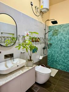 a bathroom with a sink and a toilet and a mirror at Hotel Beach Castle in Arugam Bay +34 photos