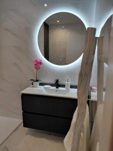 a bathroom with a sink and a mirror at A casa de Aliciña in Sanxenxo +33 photos