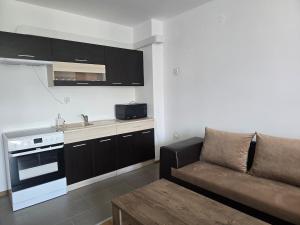 a living room with a couch and a kitchen at Artea Hisarya in Hisarya