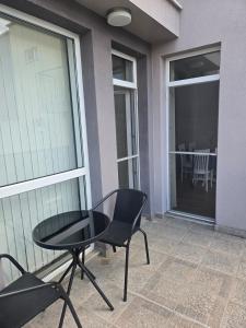 a patio with a table and chairs on a balcony at Artea Hisarya in Hisarya +4 photos