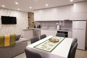 a kitchen and living room with a table and a couch at Casa da Goreti in Armamar +52 photos