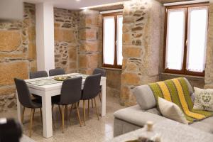a living room with a table and chairs and a couch at Casa da Goreti in Armamar