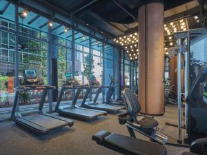 a gym with a row of cardio machines at Pullman Singapore Hill Street in Singapore