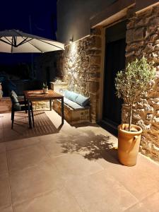 a patio with a table and a potted plant at Ellotis Stone Retreat in Áyioi Dhéka +15 photos