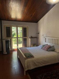 a bedroom with a large bed and a large window at Via Belvedere 50 in Montefalco +40 photos