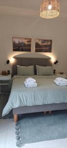 a bedroom with a bed with two towels on it at Ellotis Stone Retreat in Áyioi Dhéka