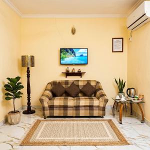 a living room with a couch and a table at Charming Home banglow in Karachi