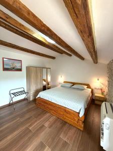 a bedroom with a bed and wooden floors at Tea Rooms III in Bale