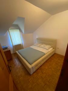 a bedroom with a bed in an attic at Estrada Cazin in Ostrožac