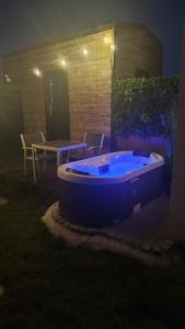 a blue hot tub in a yard at night at Maisonnette des trois frontières in Richwiller