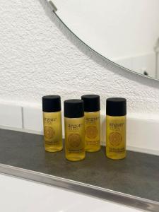 three bottles of mustard sitting on a shelf at STAY - Seeblick Apartment in Friedrichshafen
