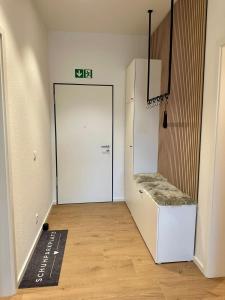 a room with a white door with a bench in it at STAY - City M17 in Tettnang