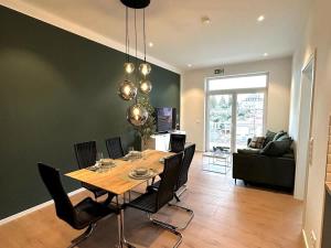 a dining room and living room with a table and chairs at STAY - City M17 in Tettnang