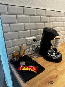 a counter with a coffee maker and drinks on it at STAY - City M17 in Tettnang +36 photos
