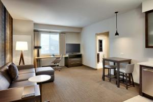 a living room with a couch and a table at Residence Inn by Marriott Lenexa City Center in Lenexa +4 photos