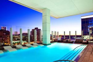 a swimming pool on the roof of a building with a city skyline at JW Marriott Atlanta Downtown in Atlanta