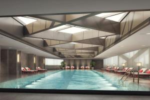 a swimming pool in a hotel lobby with a ceiling at Zhenjiang Marriott Hotel in Zhenjiang