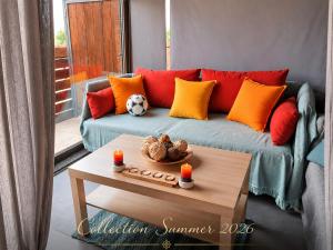 a living room with a couch with red and orange pillows at Melis House - Lake View, 75'' TV Live Football, Free Parking in Ioannina
