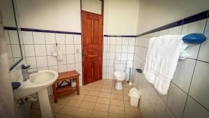 a bathroom with a sink and a toilet in it at Samara Ocean View in Sámara +21 photos