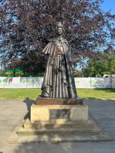 a statue of a woman standing in a park at Comfort Horizon Egham in Egham