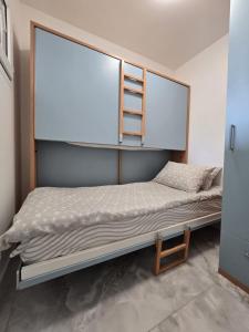 a bedroom with a bunk bed with a ladder on it at Cozy Seaside Studio with Private Parking in Nice
