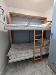 a room with two bunk beds and a ladder at Cozy Seaside Studio with Private Parking in Nice +6 photos