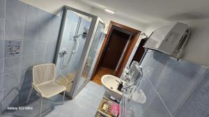 a small bathroom with a shower and a sink at Torre Serena B&B in Atella +50 photos